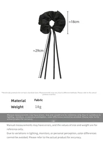 Detail view of large black satin hair scrunchie with ribbons and dimension measurements