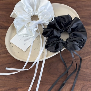 Elegant white and black satin bow scrunchies with long ribbons for ballet style hair