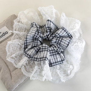 Detail shot of black and white plaid scrunchie with delicate wide lace embroidery edges