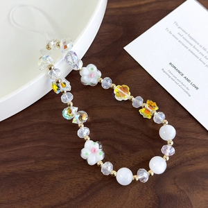 Close-up of handmade beaded phone strap with crystal beads and yellow butterfly flower charm