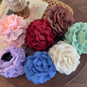 Lace floral embroidery hair claw clips in various colors displayed on a wooden tray