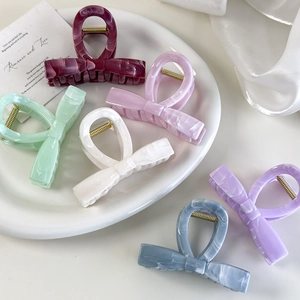 Elegant jelly-colored bow hair claws in marble texture for bun hair styling accessories