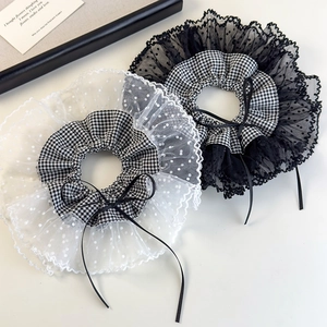Detail view of retro lace scrunchies with black and white plaid and delicate bow accents