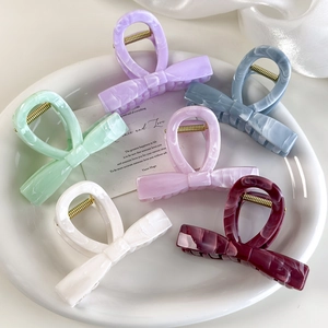 Colorful marble textured bow hair claws in six soft spring jelly colors for women