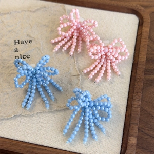 Détails de clips chaussures faits main avec nœuds en perles et glands en rose et bleu