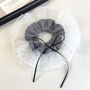 Detail shot of black and white plaid scrunchie with lace mesh and silk ribbon bow