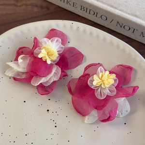 Detailed view of layered pink mesh flower earrings with soft chiffon fabric texture