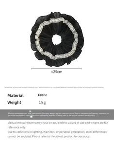 Detail view of large 25cm black scrunchie with white lace trim and ruffled design