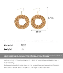 Detail view of round woven straw earrings showing 6.7cm height and 4.8cm width dimensions
