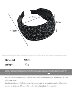 Detail view of black floral fabric headband with size and weight measurements provided