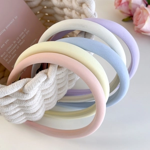 Set of pastel sponge headbands in macaron colors displayed in a woven basket
