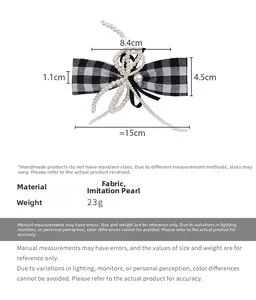 Detail of houndstooth bow hair clip with pearls showing dimensions of 15cm span