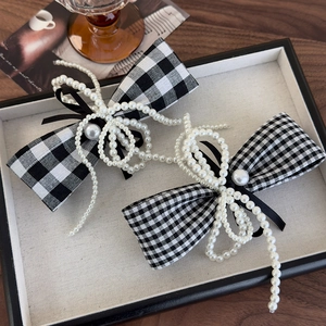 Elegant houndstooth bow hair clips with faux pearl accents in a vintage set of two
