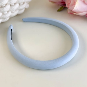 Detail view of light blue padded headband with soft fabric texture and non-slip inner lining