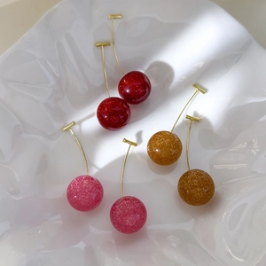 Sparkling resin cherry earrings in red, pink, and yellow with gold-tone metal studs