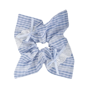Detail of blue gingham scrunchie with white lace trim, light blue ribbon and white pearls