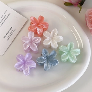 Detail view of 6-piece marble-textured flower hair claws in assorted Morandi colors