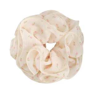 Floral print oversized chiffon scrunchie with pastel pink blossoms on cream fabric