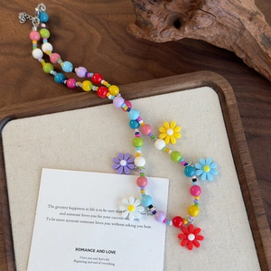 Close-up of a colorful daisy beaded necklace with vibrant flower charms and silver clasp