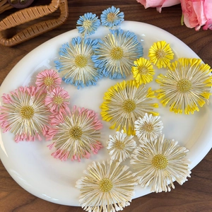 Colorful layered sunflower earrings set in blue, yellow, pink, and white floral styles