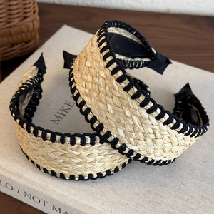 Bohemian style woven straw headband with black stitched edges for beach vacation look