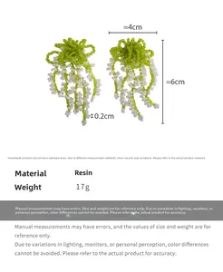 Detail showing green resin beaded tassel earrings with size dimensions 6cm by 4cm