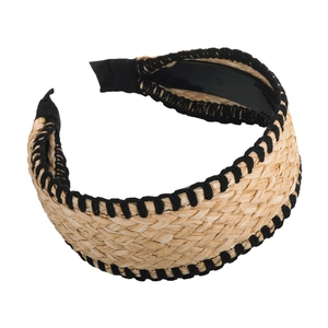 Bohemian style wide straw woven headband with black stitched edges on white background