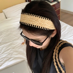 Bohemian woven straw headband with black trim detail for beach and vacation style