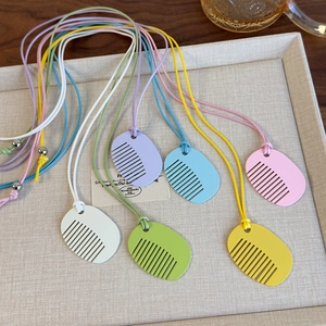 Colorful comb-shaped pendant necklaces on woven ropes in six vibrant summer shades