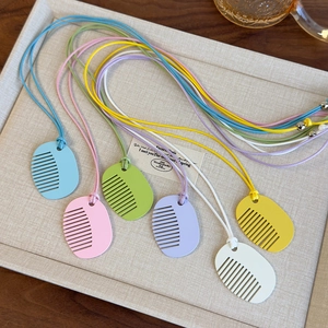 Colorful comb-shaped pendant necklaces in pastel macaron shades for minimalist summer style