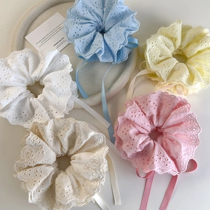 Detail of four-layer lace scrunchies with floral embroidery and long satin ribbons