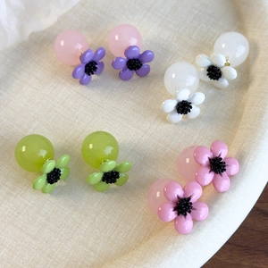 Set of four pastel resin flower stud earrings with large bead backings in various colors