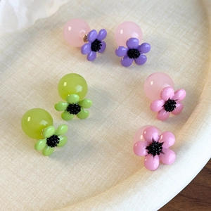Detailed set of three pairs of cherry blossom resin flower earrings in pastel colors