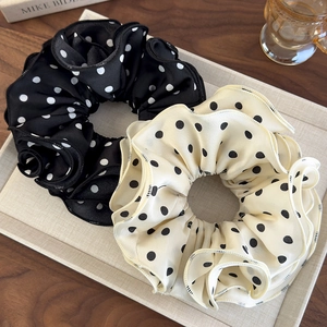 Elegant black and white polka dot chiffon scrunchies set in a rustic decorative tray