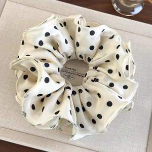 Elegant ivory chiffon scrunchie with black polka dots and delicate black stitched edges