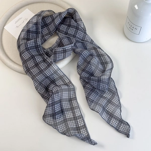 Modern thin plaid skinny scarf in classic grey and black checkered pattern on tray