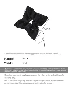 Detail view of a black lace bow hair tie with long ribbons and dotted fabric texture
