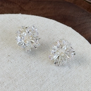 Elegant silver flower stud earrings with sparkling cubic zirconia and small white pearls