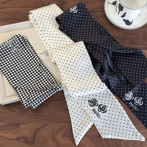 Elegant French style narrow silk scarves with polka dots and floral patterns on wood
