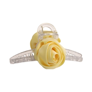 Detailed close-up of handmade yellow silk fabric roses on a transparent hair claw clip