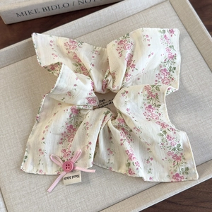 Detail of floral scrunchie with pink ribbon bow button and Hand Made fabric label