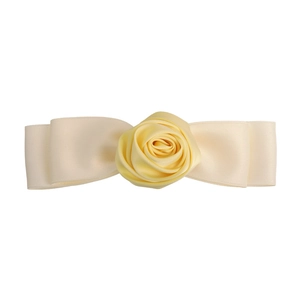Detail of handmade yellow satin rose hair clip with elegant silk ribbon bow design