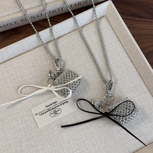 Silver bead chain necklace with metal heart and hollow bag pendant and bow accent