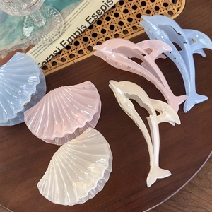 Jelly-colored shell and dolphin hair claws in pastel blue, pink, and pearl white