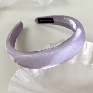 Detail of lavender satin padded headband with internal handmade label and premium texture
