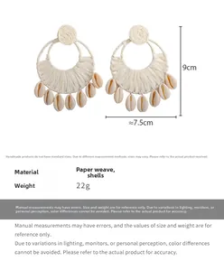Detail view of large bohemian woven hoop earrings with shells and size measurement