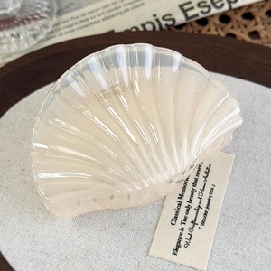 Detailed close-up of shell-shaped jelly resin hair claw with pearlescent glitter texture
