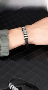 Macro detail of men's punk leather bracelet with engraved silver steel magnetic clasp