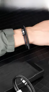 Close-up of men's double-layer leather and woven bracelet with silver magnetic clasp