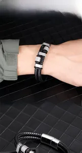 Macro view of double-layer braided leather bracelet with knurled silver magnetic clasp